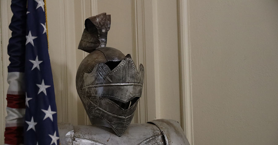 American flag next to a knight statue.