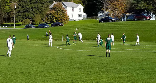 soccer players attempt to head a ball during a game