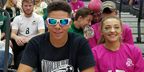 two students pose for a picture at the pep rally