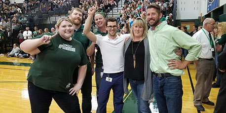 teachers pose for a picture at the pep rally