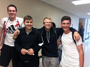 a picture of four MCS students smiling at the camera