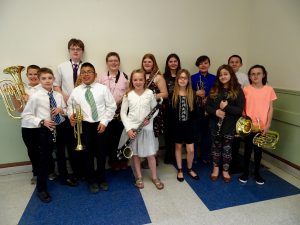 mcs elementary band students pose with their insturments