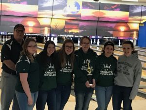 the girls varsity bowling team poses with their trophy