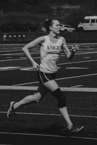 olivia hamm runs during a track meet