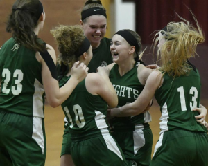 Kelsey Terrell celebrates with her teammates after scoring her 1,000th point