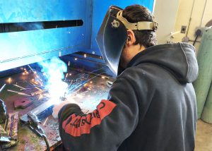middleburgh student Louis Michaels welds during a class