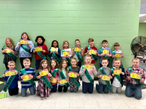 mes students pose with their student of the week awards