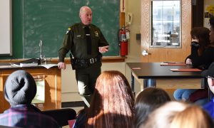 students listen to a presenter during career day