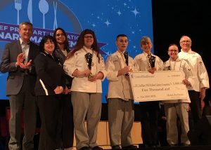 Logan Stephens stands with his teammates on the Capital Region Culinary Team after winning the state competition