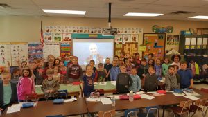 2nd grade students pose with dr. jane goodall after a skype in the classroom event
