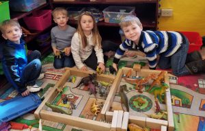 pre-k students pose for a picture while learning about dinosaurs