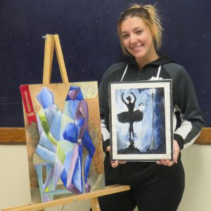 Keirsten Mickle poses with her artwork.