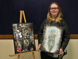 Rebecca Buskey poses with her artwork.