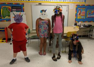 students show off their work during the summer enrichment program