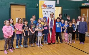 students pose with elementary school principal amy irwin