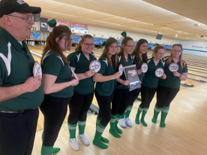 girls bowling poses with their sectional patches