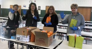 food service workers with grab and go meals