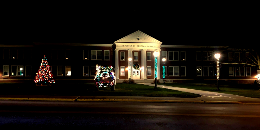 holiday tree and tractor and lampposts decorated in lights