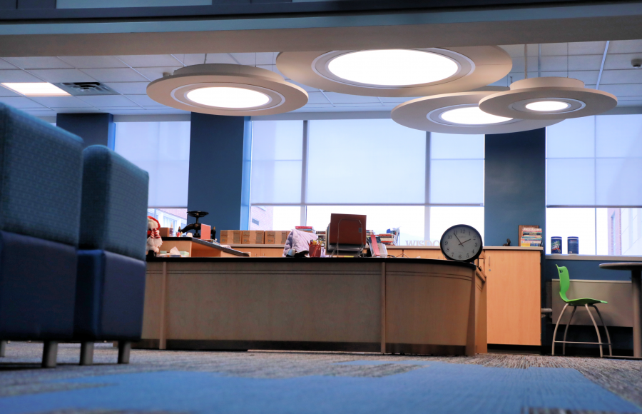 Big windows behind front desk of moden school library