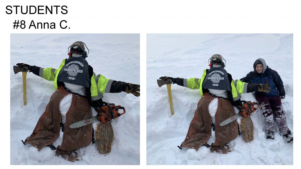 Snowman dressed up as an outdoor worker with an axe and chainsaw, gloves, jacket, hat, sunglasses. Student sits in snow with arm around snowman.