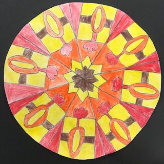 Tibetan Mandala mostly yellow, red and orange, with a brown star-like shape in the middle