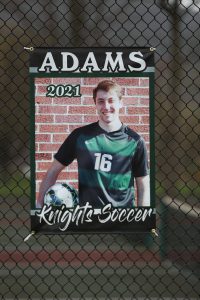 soccer player holding ball on hip
