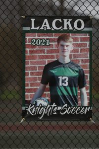 soccer player with red hair and ball on hip