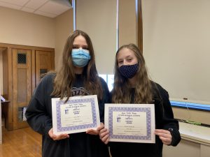 two fbla students holding certificates