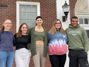 five sophomores stand with arms around each other outside the high school 