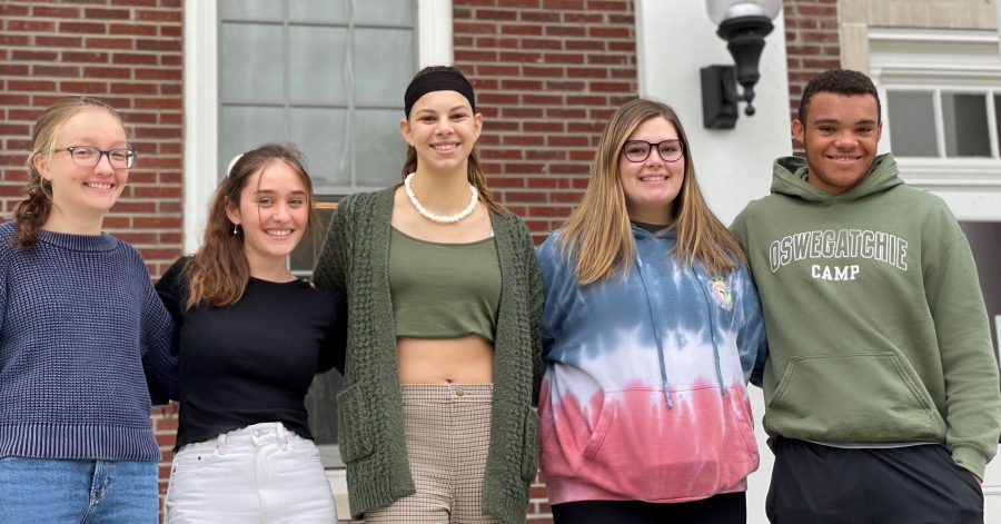 five sophomores stand with arms around each other outside the high school