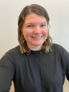 woman with light blonde hair smiles for the camera