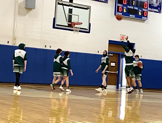 basketball players on the court one throws for the hoop