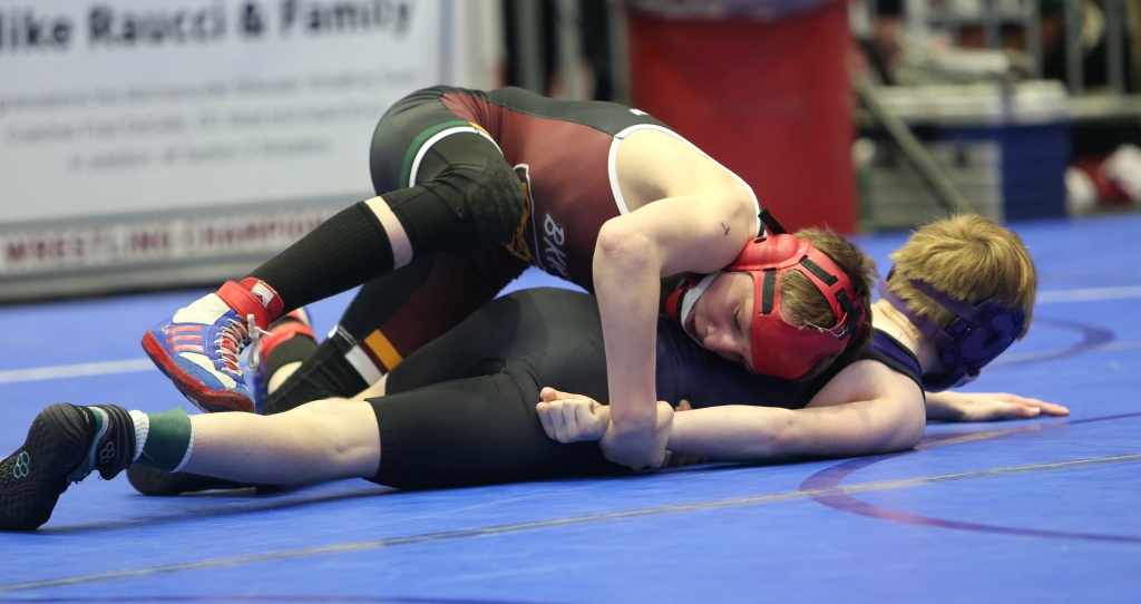 student wrestler pins his opponent 
