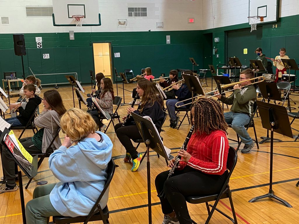 students playing instruments in a school gym