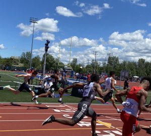 track stars running across the finish line