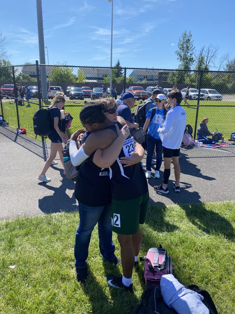 runner hugs mom off the track