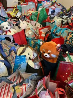 A large collection of stuffed animals and gift bags