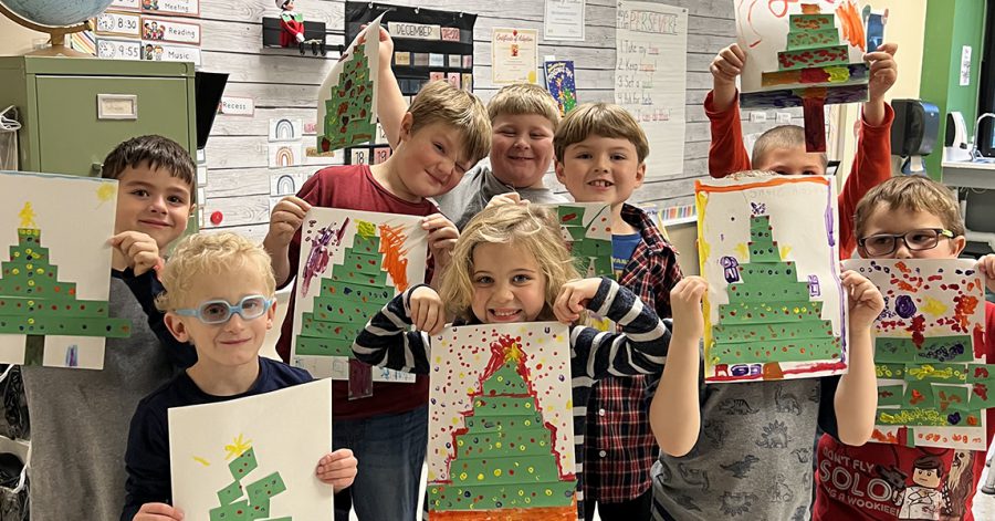 Students show off their Christmas tree artwork