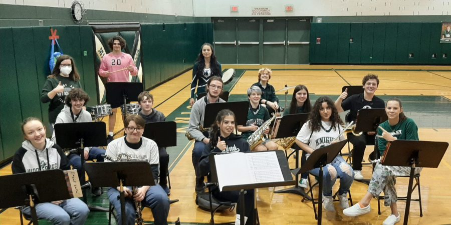 Members of the Middleburgh Band are seated together before the school pep rally. Many are wearing green shirts to show their school spirit.