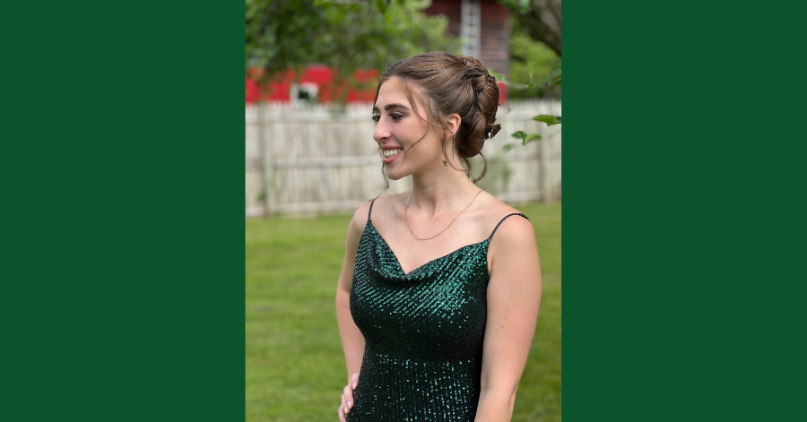 Teenage girl poses in a prom dress.