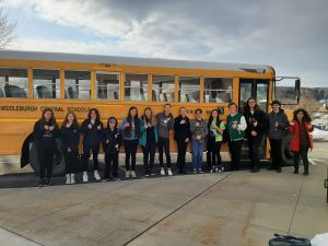 All County 2023 students stand in front of bus.