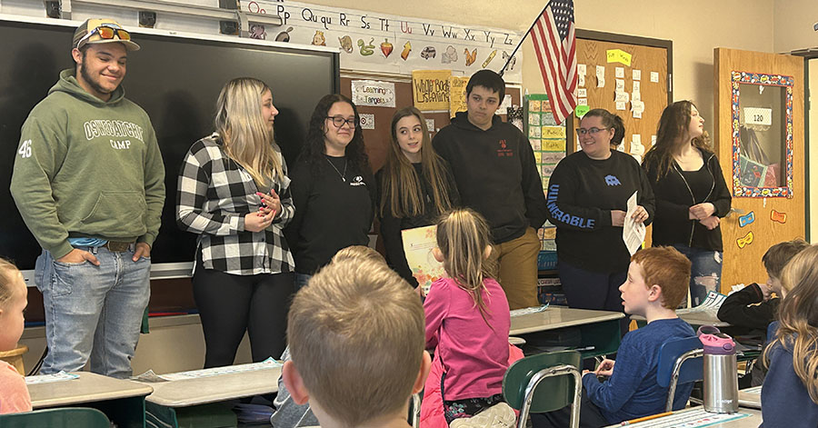 High school students give presentation to elementary students.