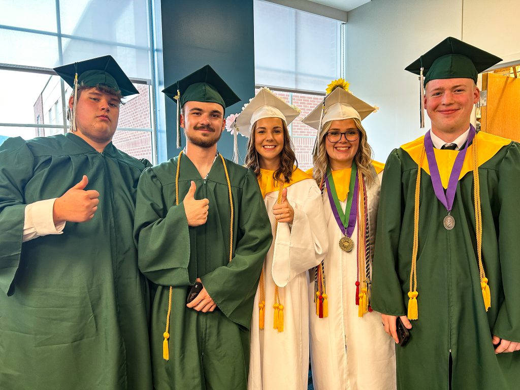 Students give thumbs up at graduation