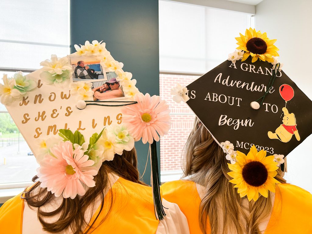Mortar boards decorated with flowers and inspirational sayings.