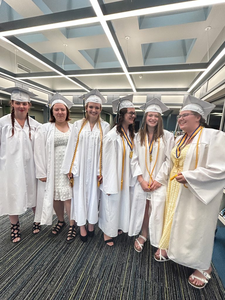 Six students in cap and gowns