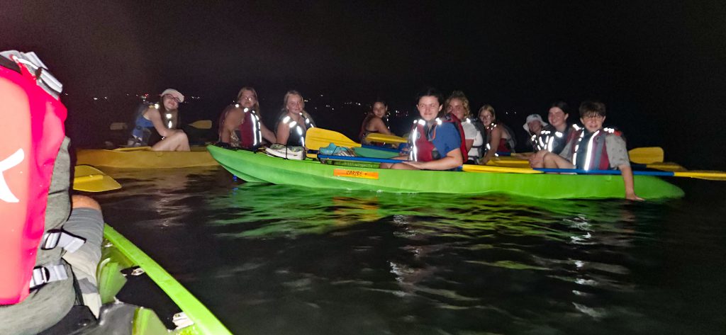 Student kayak at night.