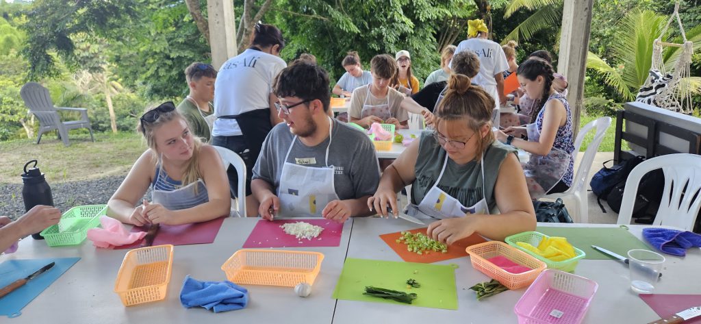 Students cutting up vegetables.