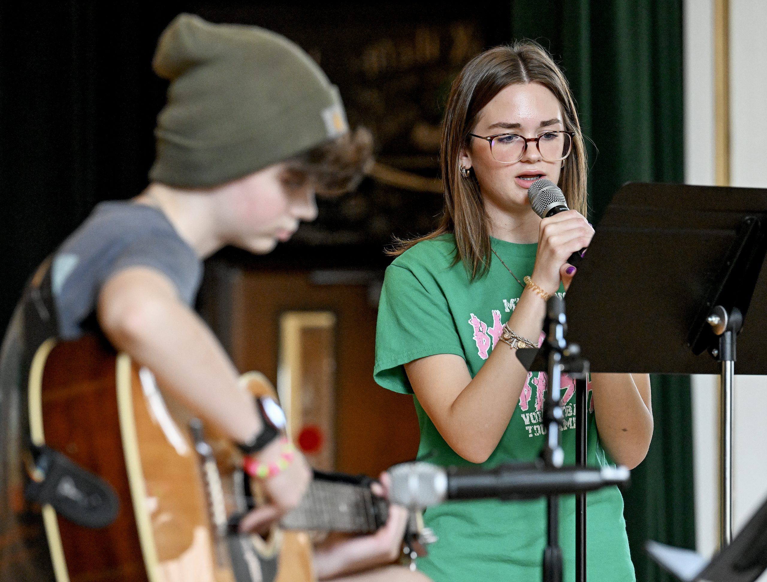 Students sing and play guitar on stage