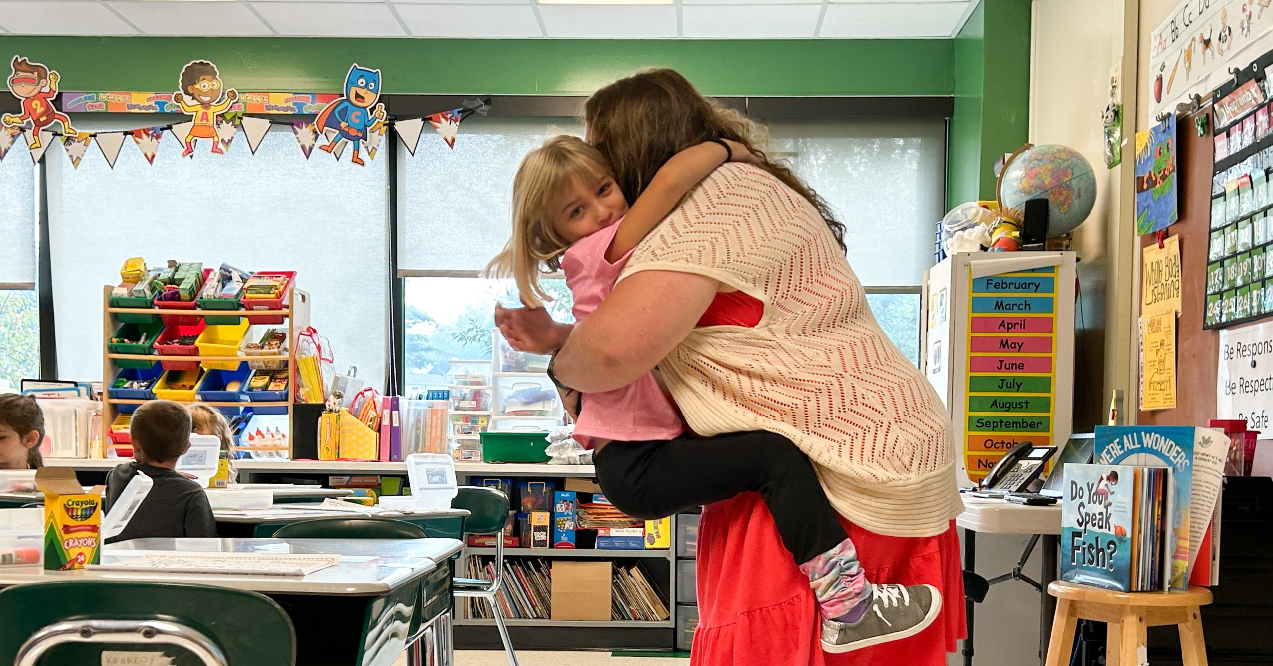 Girl jumps into a teacher's arms.