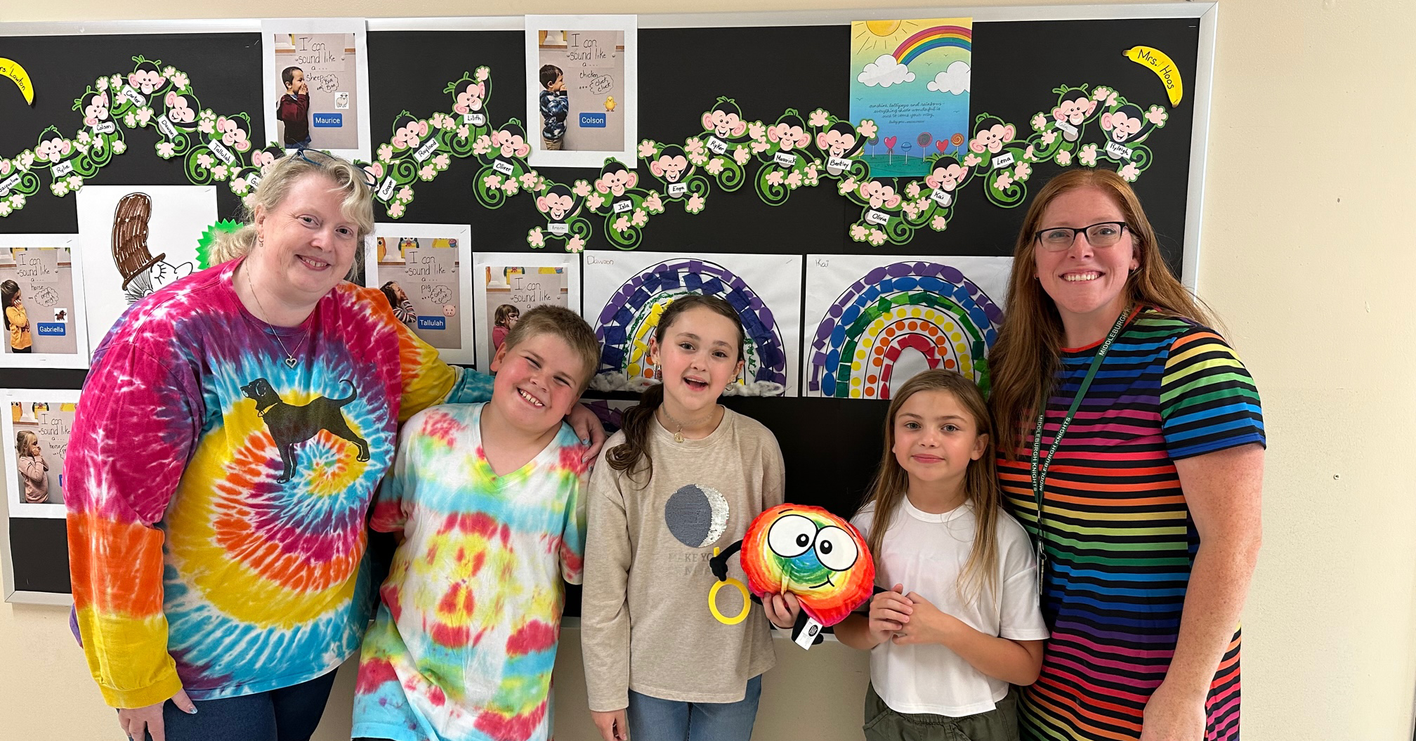 Students and teachers dressed in rainbow clothing.